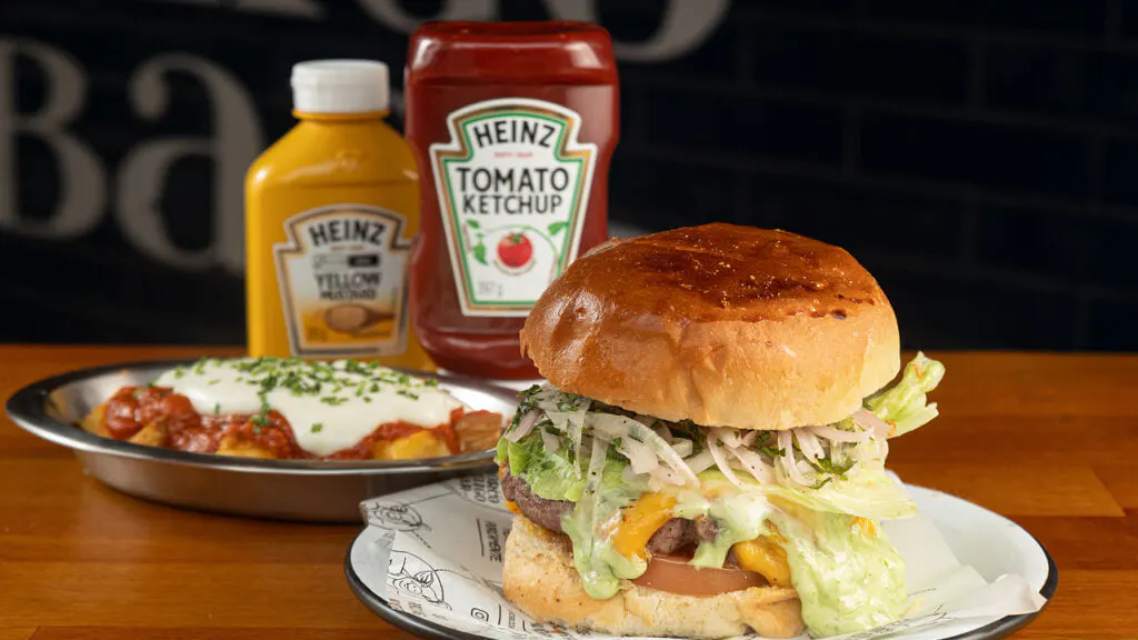 Cheese Swine Salad: handmade pork and beef burger on brioche bread, melted wound, lettuce, tomato, and salad