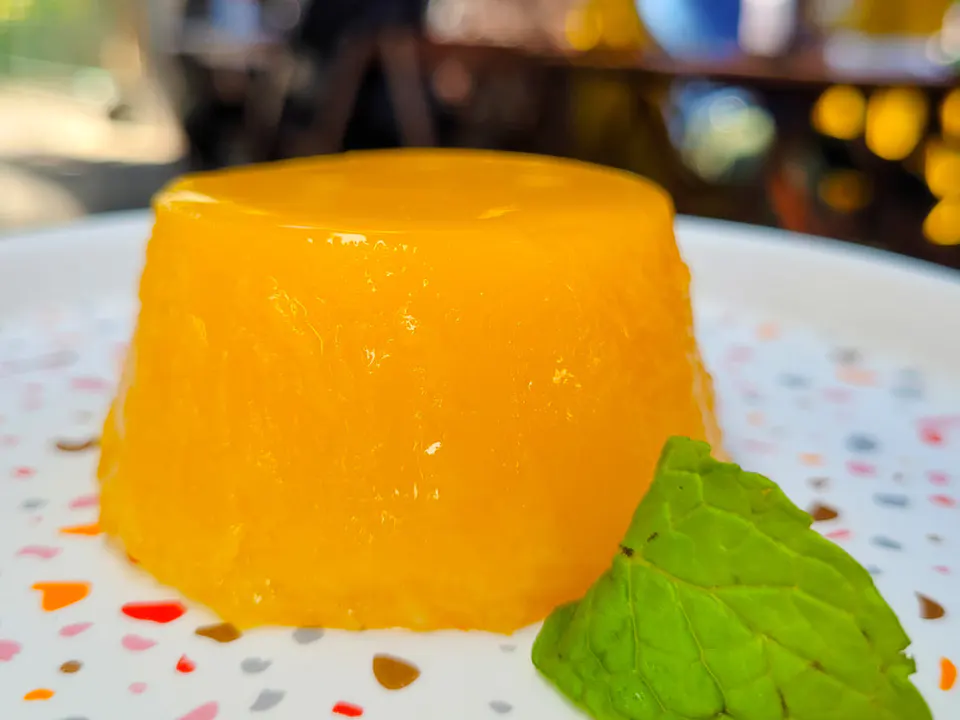 Alloram giallo brillante decorato con foglia di menta, in piatto bianco con timbro di colore
